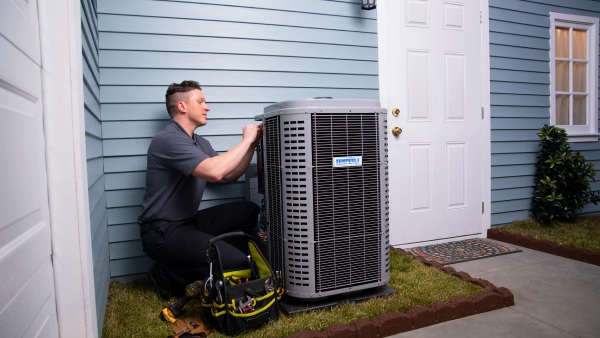 hvac tech working on unit outdoor