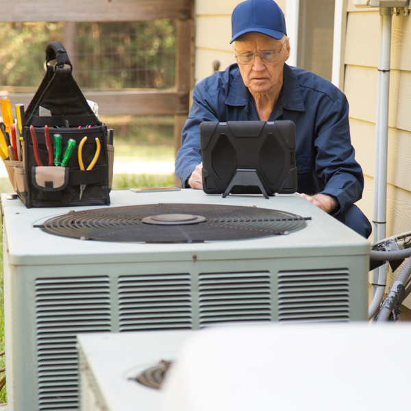 hvac tech talking to man on kitchen showing brochure